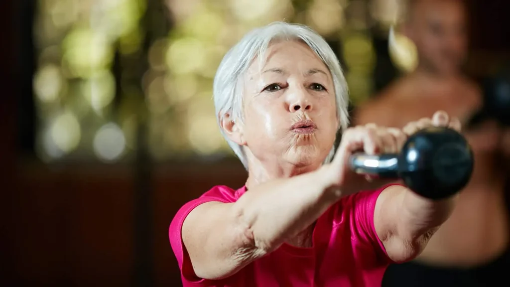 Toning Arms Without the Bulk: Is It Achievable? 1 Woman doing resistance band exercises for toned arms Wellingborough
